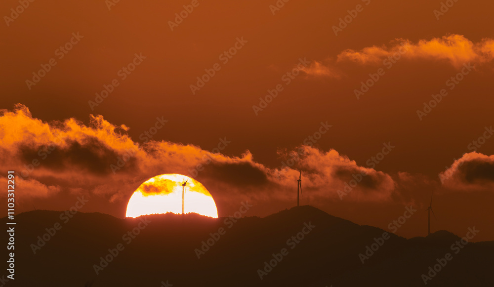 breathtaking sunrise over distant hills with wind turbines surrounded by dramatic amber clouds blending renewable energy nature beauty and serene harmony of sustainability and environmental balance breathtaking sunrise over distant hills with wind turbines surrounded by dramatic amber clouds blending renewable energy nature beauty and serene harmony of sustainability and environmental balance