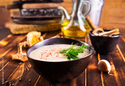 Musroom soup served with parsley leaf. photo