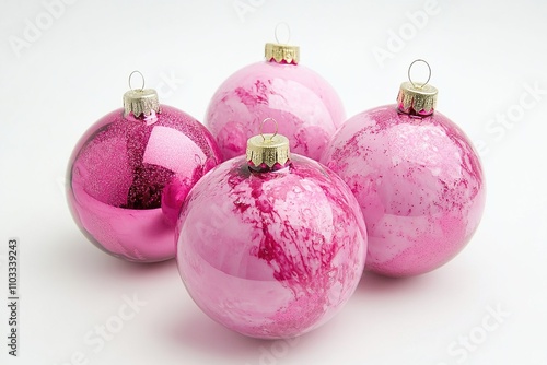 Christmas decoration. Pink and silver colored christmas baubles on pink background.