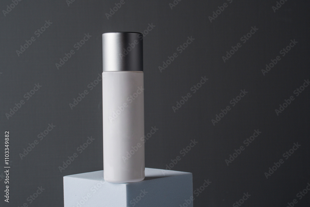 White sunscreen bottle on grey background. Sunscreen concept. Skin care concept. Copy space. White sunscreen bottle on grey background. Sunscreen concept. Skin care concept. Copy space.