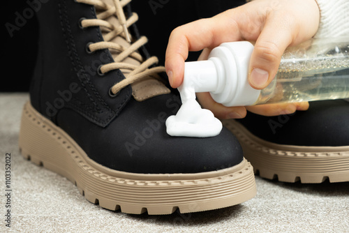 Shoe care, applying cleaning foam to the boot photo