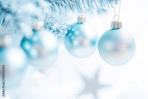 A delicate silver ornament hangs from a Christmas tree, reflecting the soft glow of holiday lights.