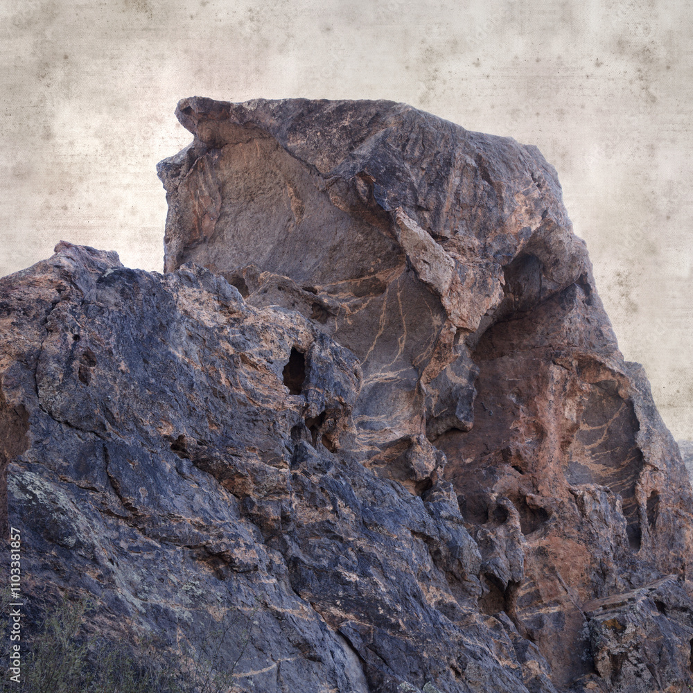 textured stylish old paper background, square, with landscape of Gran Canaria, around the Dog of Bentayga rock formation textured stylish old paper background, square, with landscape of Gran Canaria, around the Dog of Bentayga rock formation