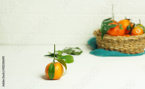 Ripe tangerines with leaves on the kitchen table