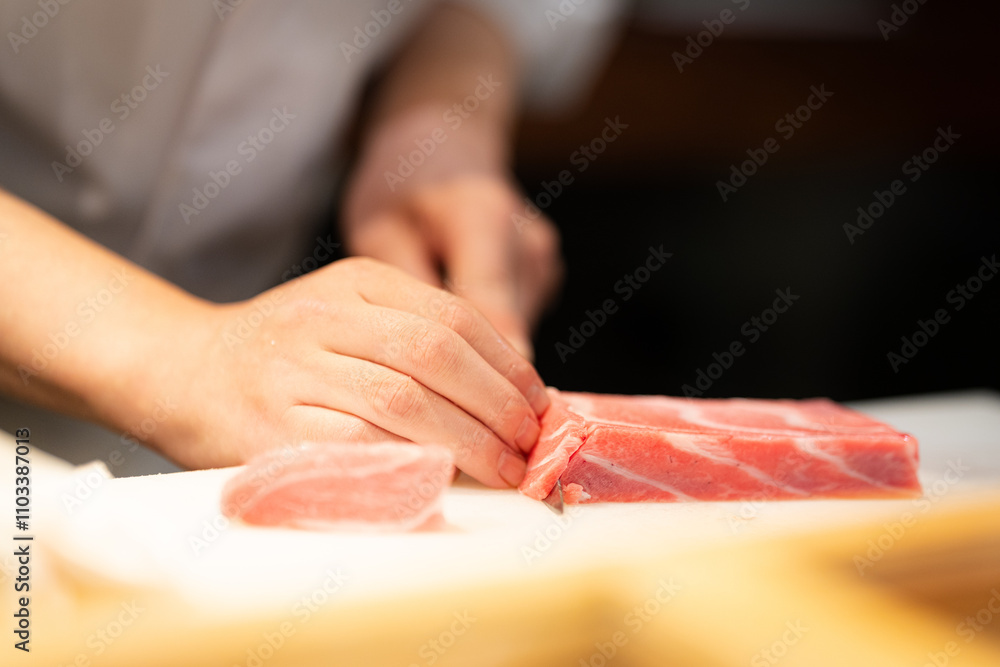Sushi chef slicing red tuna at an omakase restaurant in Tokyo