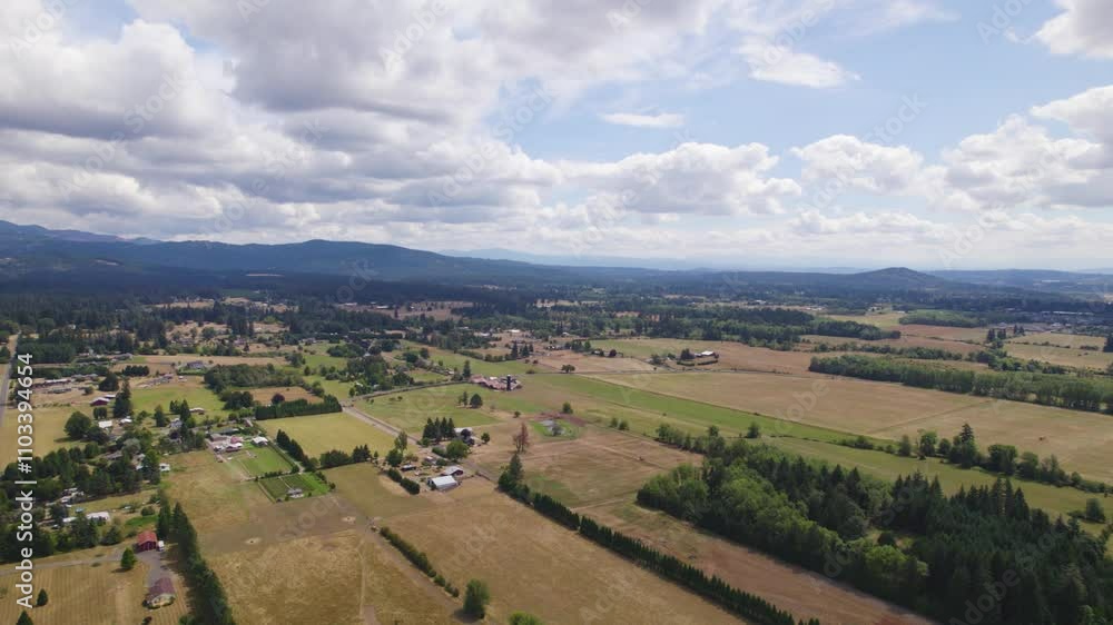 Aerial perspective of white clouds gliding over the vibrant green pastures of Battleground, WA Aerial perspective of white clouds gliding over the vibrant green pastures of Battleground, WA