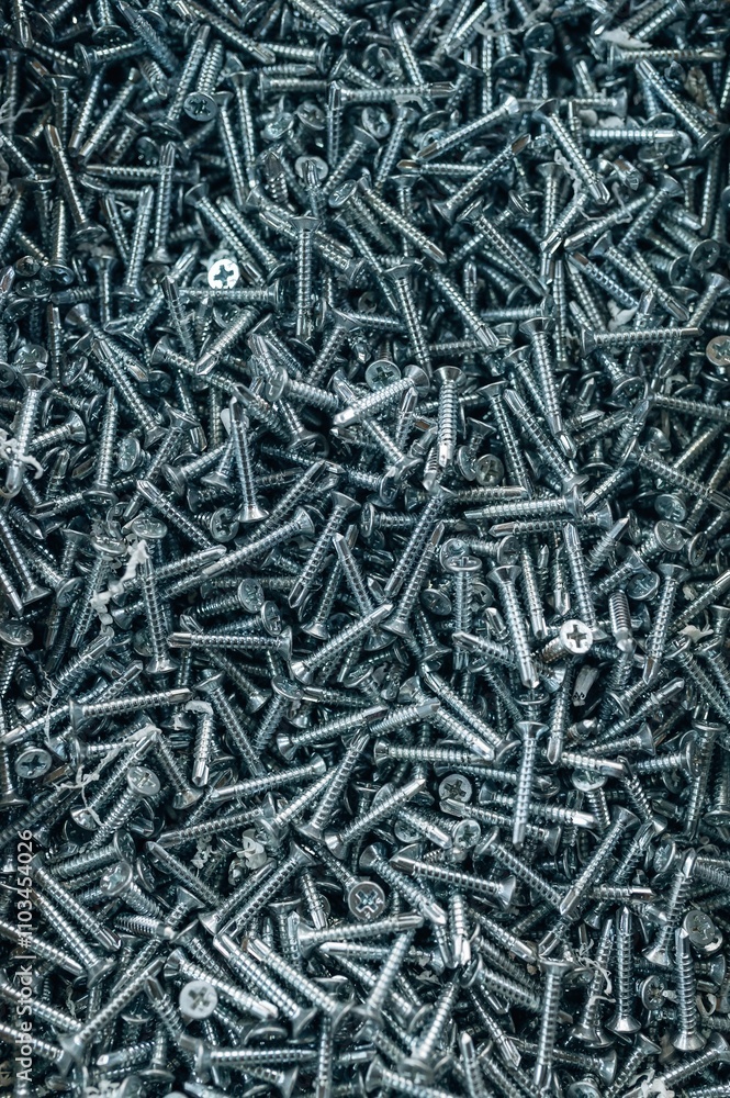 Bunch of galvanized stainless screws with flat countersunk head, hardware background Bunch of galvanized stainless screws with flat countersunk head, hardware background
