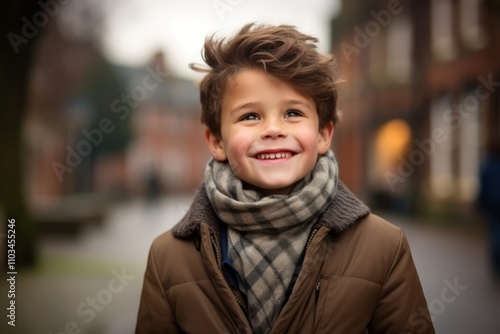 Portrait of a cute little boy wearing warm clothes and scarf outdoors