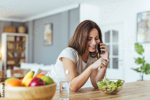 Smiling Woman Enjoys Healthy Salad During Phone Conversation photo