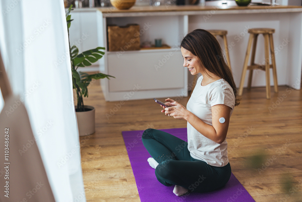 Young Woman Using Smartphone While Relaxing on Yoga Mat at Home Young Woman Using Smartphone While Relaxing on Yoga Mat at Home