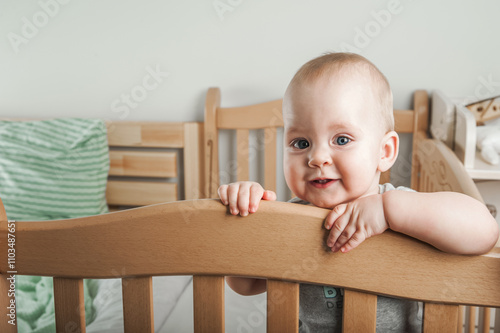 Curious Baby Standing in a Wooden Crib