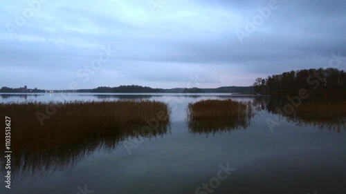 Melancholic lake in the afternoon, in lithuania. Claudy day and almost night. photo