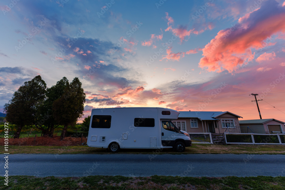 Motorhome parked on the road with sunrise sky among vineyard in countryside Motorhome parked on the road with sunrise sky among vineyard in countryside