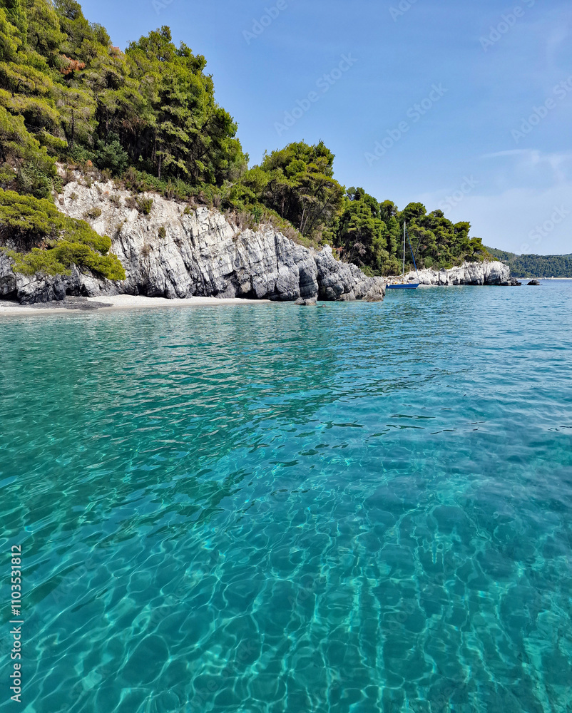 Fototapeta premium Rocky coast with turquoise sea. Greek island of Skopelos, Greece, Europe.