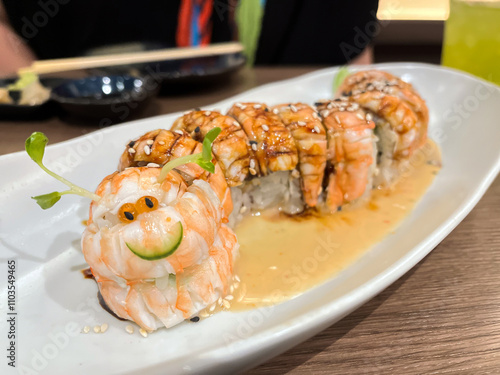 Creative sushi presentation shaped like a caterpillar. photo