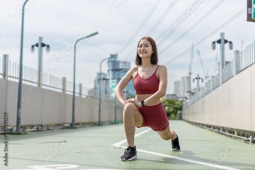 Young beautiful woman sportswear workout clothes exercise in street city park before morning run. Asian strong female sporty sportswear stretching outdoors. fitness healthy concept.