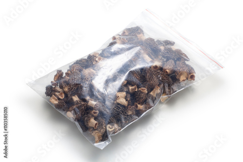 Dried morel mushrooms in a transparent plastic bag photo