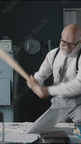 Angry businessman destroying his laptop