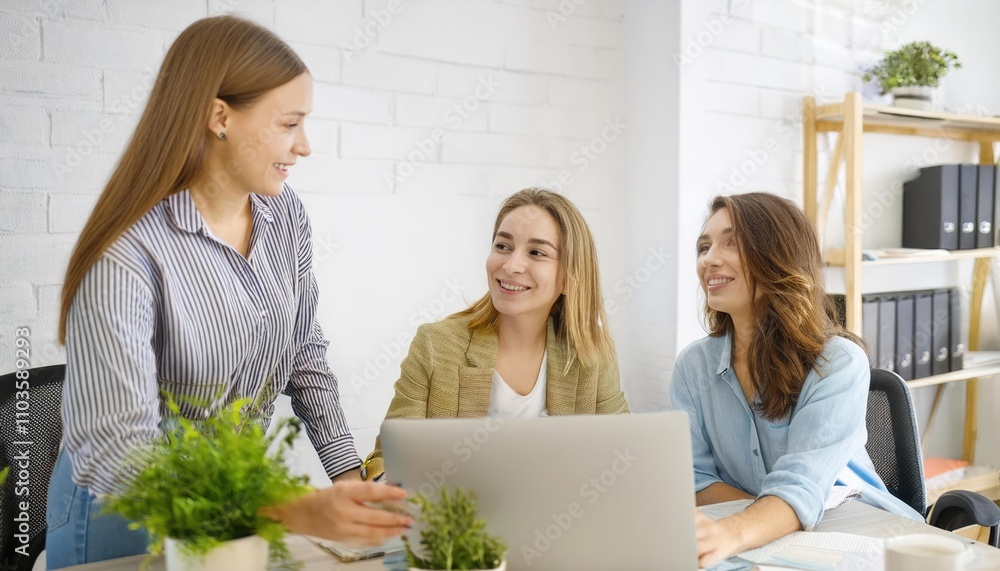 happy two young female graphic designers discussing with colleague in office. Creative people working together using computer at desk happy two young female graphic designers discussing with colleague in office. Creative people working together using computer at desk
