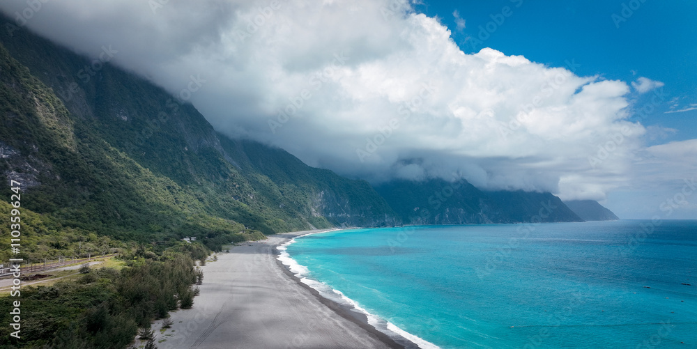 Stunning coastal view of Taiwan with lush mountains and vibrant blue ocean under a cloudy sky Stunning coastal view of Taiwan with lush mountains and vibrant blue ocean under a cloudy sky