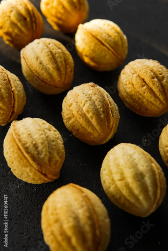 Oreshek cookies on a black background.Nuts dessert.Nut cookies on a dark background.Nut cookies on a black background.cookie photo