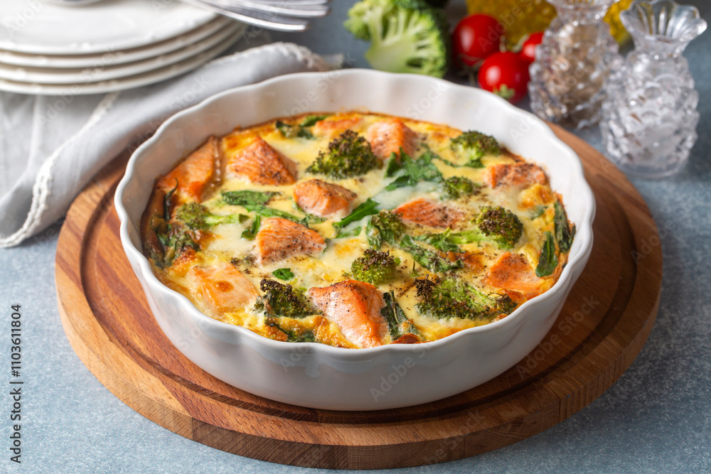 Egg-based frittata, omelette with salmon, broccoli and spinach. Italian dish, crustless quiche with eggs, fish and vegetables. Mediterranean ketogenic healthy diet.