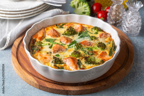 Obraz na płótnie Egg-based frittata, omelette with salmon, broccoli and spinach. Italian dish, crustless quiche with eggs, fish and vegetables. Mediterranean ketogenic healthy diet. w salonie