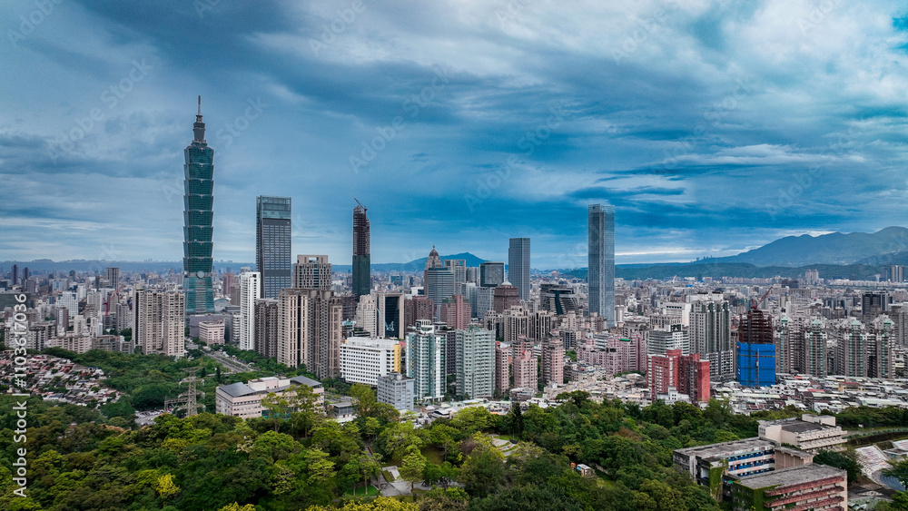 Fototapeta premium Panoramic view of Taipeis skyline with skyscrapers and lush greenery in front