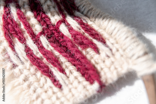 A macramé wall hanging featuring the Georgian flag design, highlighting the texture of the woven fabric and the neat craftsmanship of the reverse side