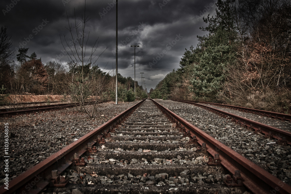 An old railway track disappears into the distance. An old railway track disappears into the distance.