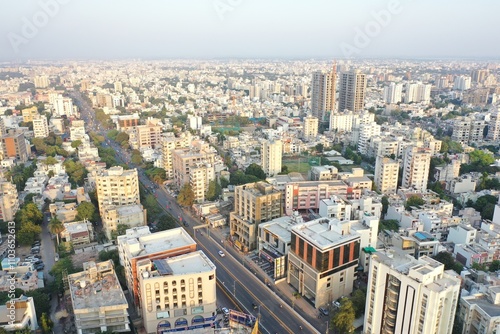 Rajkot, Gujarat, India, 11 28 2024 city view of the sunset time traffic and peoples are going to home from work aerial drone view commercial showroom around many building in Rajkot