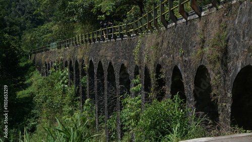 Portrait of the Plunyon Bridge over the Kalikuning river with beautiful and amazing views located on the slopes of Mount Merapi. photo