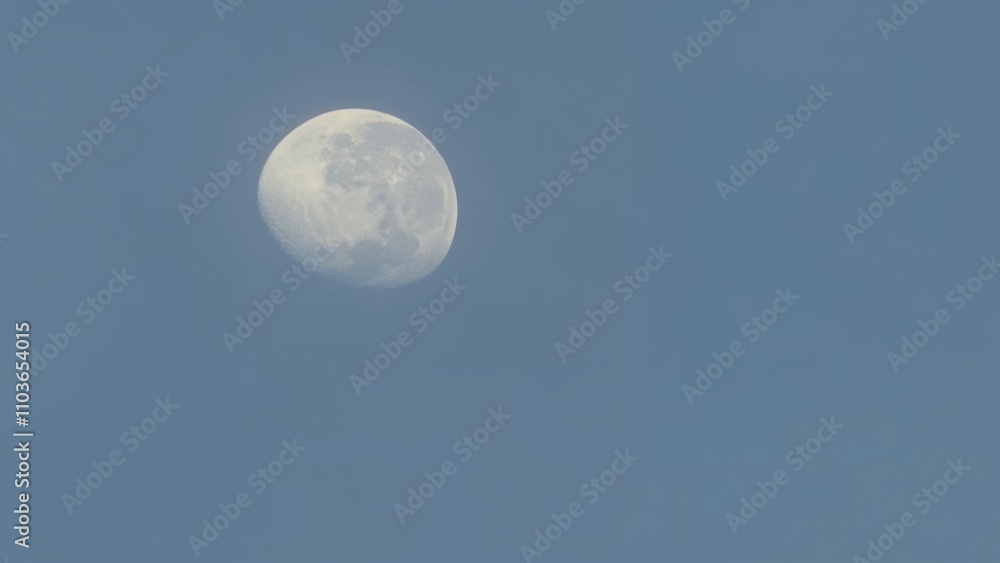 Daytime Moon Glimpsed in a Pale Blue Sky: A Celestial Observation Daytime Moon Glimpsed in a Pale Blue Sky: A Celestial Observation