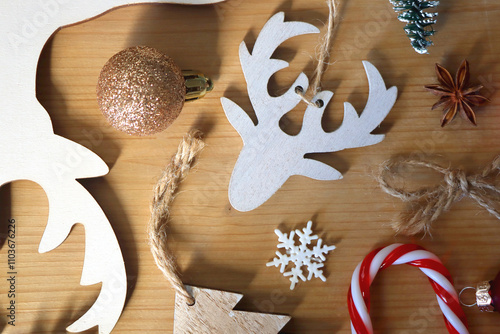 Various Christmas decorations in neutral colors on wooden background. Flat lay.