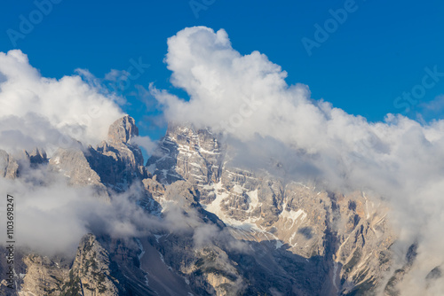 Dolomites mountains nasty weather in autumn with dark cloudy sky before the storm. Black clouds on the sky above the mountain rocky summits and peaks, stormy weather in the Dolomiti Alps, Italy. Extre photo