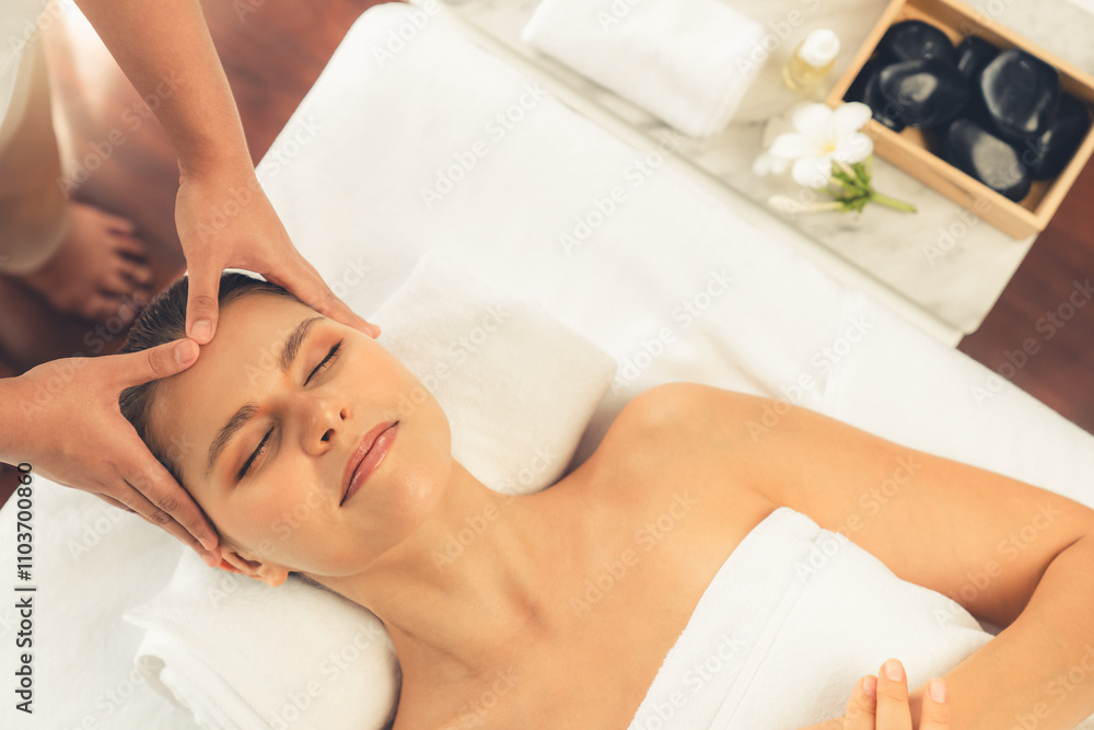 Panorama top view of woman enjoying relaxing anti-stress head massage and pampering facial beauty skin recreation leisure in dayspa modern light ambient at luxury resort or hotel spa salon. Quiescent Panorama top view of woman enjoying relaxing anti-stress head massage and pampering facial beauty skin recreation leisure in dayspa modern light ambient at luxury resort or hotel spa salon. Quiescent