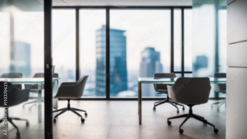 Fototapeta premium Soft blur a modern office with workspace and a blurred view of a high-rise city outside the office window.