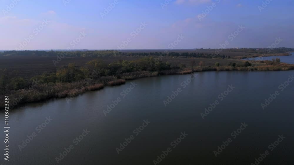 Serene river landscape showcasing lush greenery and calm waters at dusk Serene river landscape showcasing lush greenery and calm waters at dusk