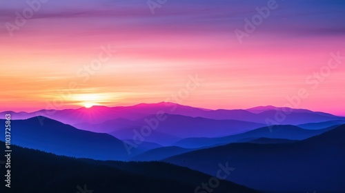 A sunrise over the mountains, with the sky transitioning from peach to violet.