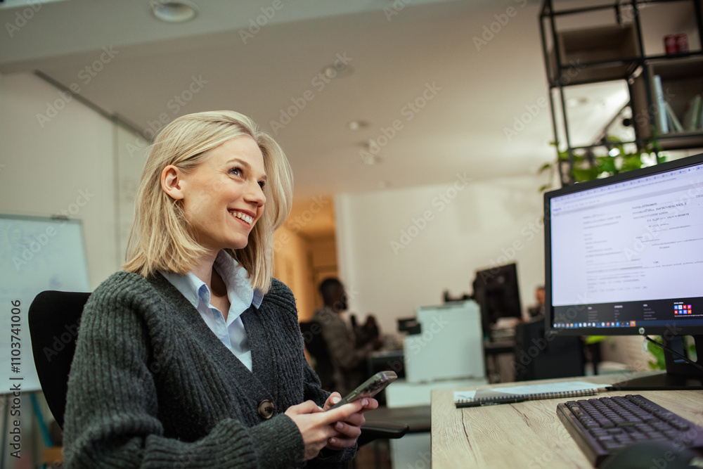 Relaxed woman using smartphone in office chair, taking a break from work Relaxed woman using smartphone in office chair, taking a break from work