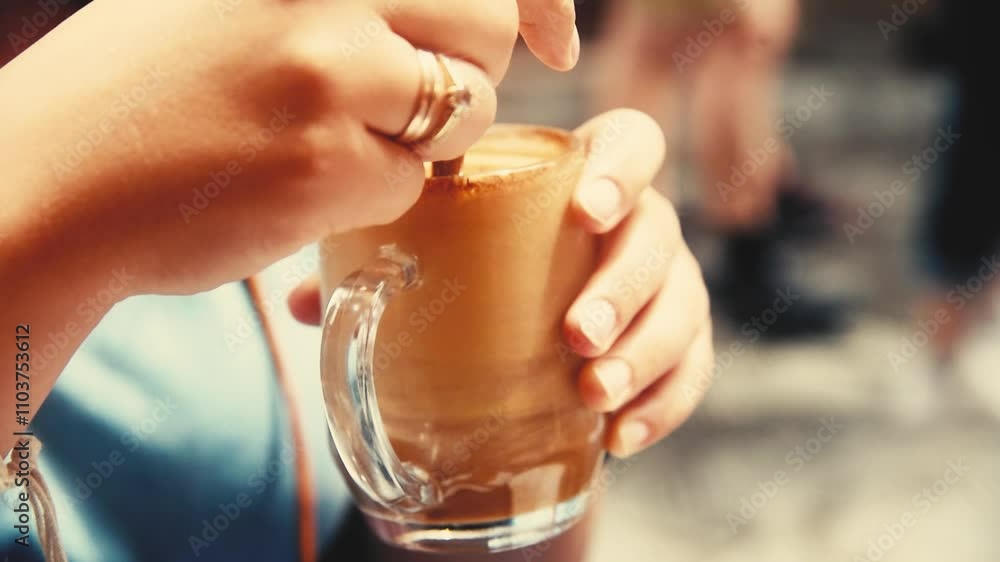 Stirring coffee at an outdoor terrace relaxing close-up Stirring coffee at an outdoor terrace relaxing close-up