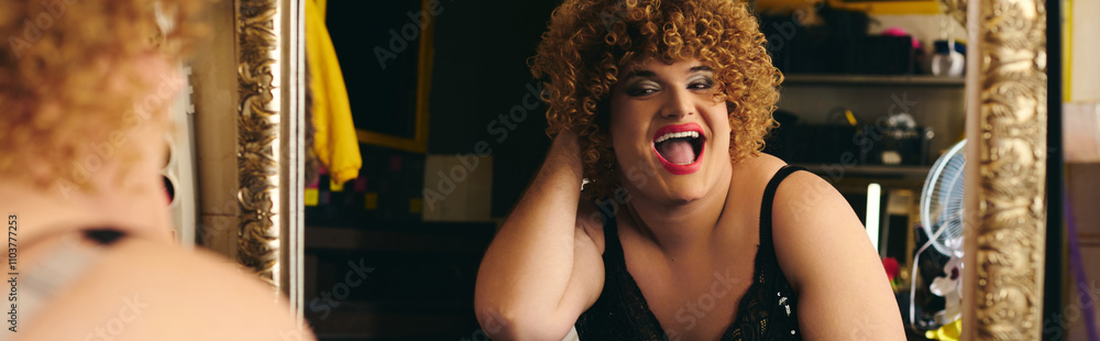 Fototapeta premium Preparing for a holiday show, the drag queen showcases artistic makeup skills near a mirror.