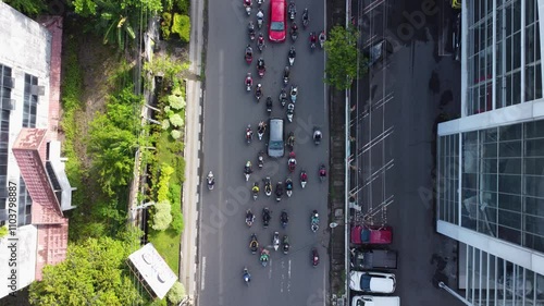 The long flyover in Banjarmasin is passed by many cars and motorbikesCar and motorbike activity on the Banjarmasin city flyover during a very busy working day