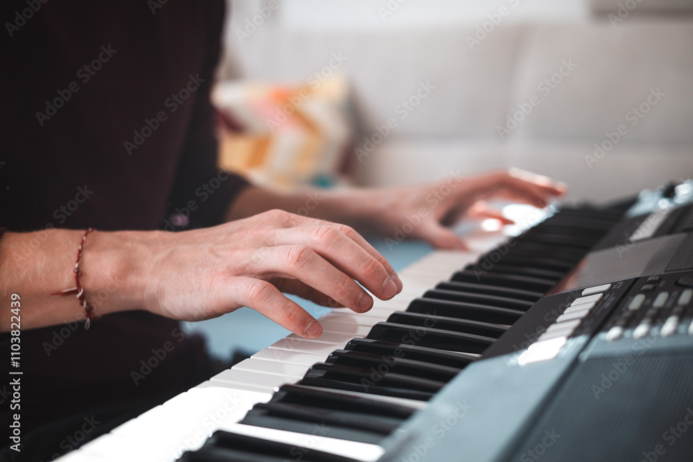 Close-up of a digital keyboard with a hand playing a melody, illuminated by soft natural light. The detailed controls and keys evoke creativity and musical exploration Close-up of a digital keyboard with a hand playing a melody, illuminated by soft natural light. The detailed controls and keys evoke creativity and musical exploration