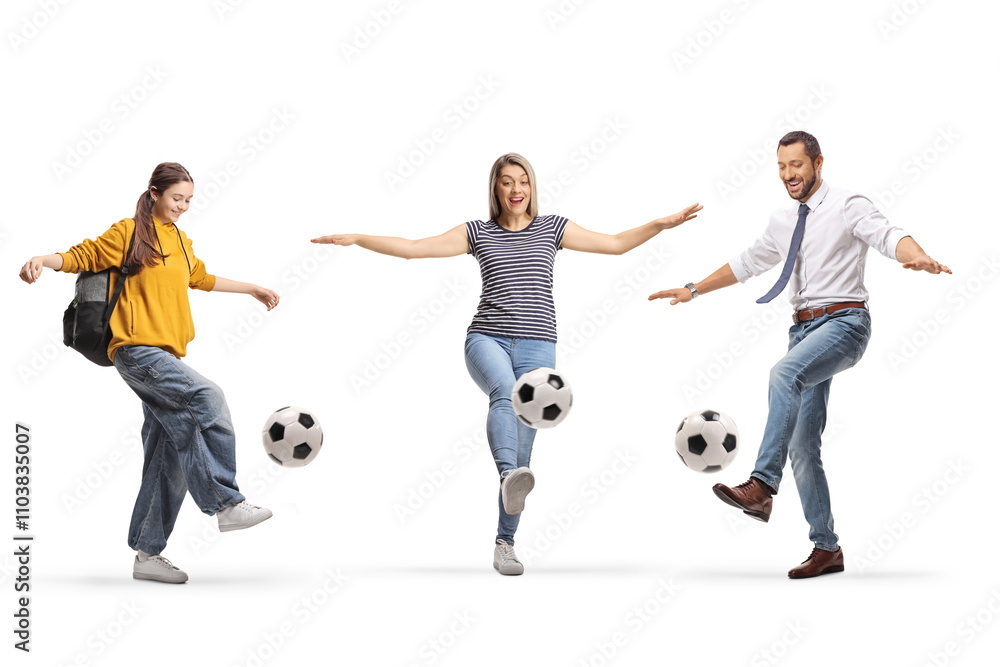 Mother, father and daughter kicking footballs and smiling Mother, father and daughter kicking footballs and smiling