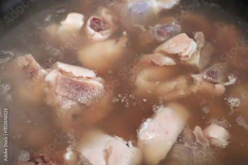 Quadro em tela The pork trotters are blanched in a pot