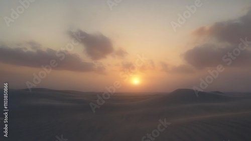 Sunset over rolling sand dunes. Warm colors paint the sky as the sun dips below the horizon.