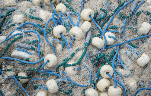 Pile of commercial fishing net for your marine texture background, closeup view. Heap of tangled fisher nets with sea ropes, abstract pattern for design of fishery industry. photo