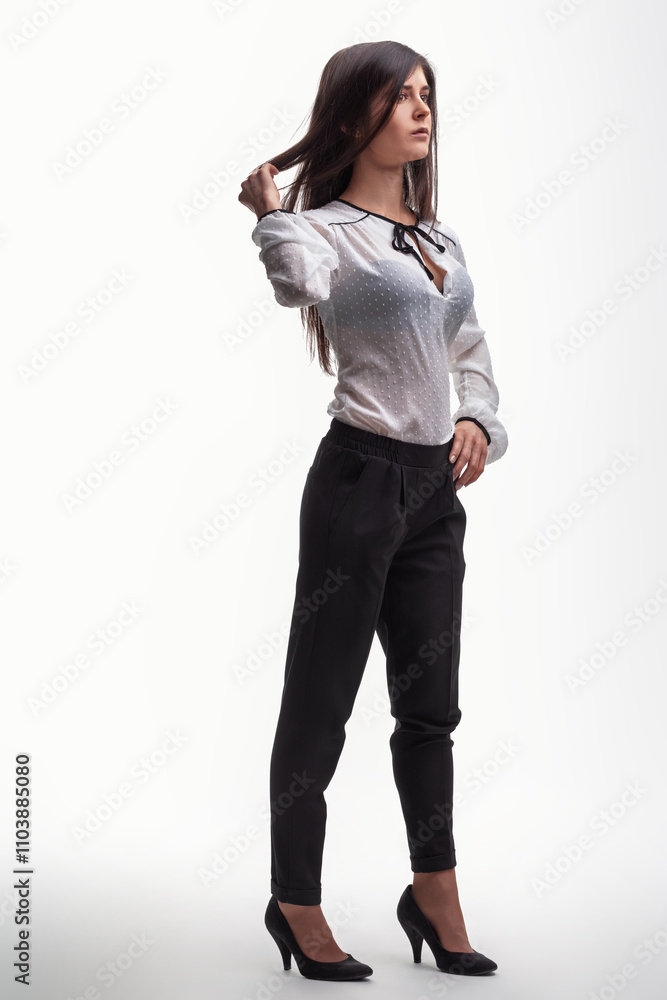 Young businesswoman touching hair and looking away on white back Young businesswoman touching hair and looking away on white back
