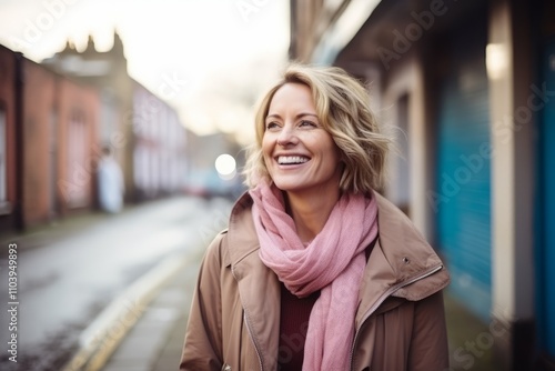 Portrait of a beautiful middle-aged woman smiling on a city street